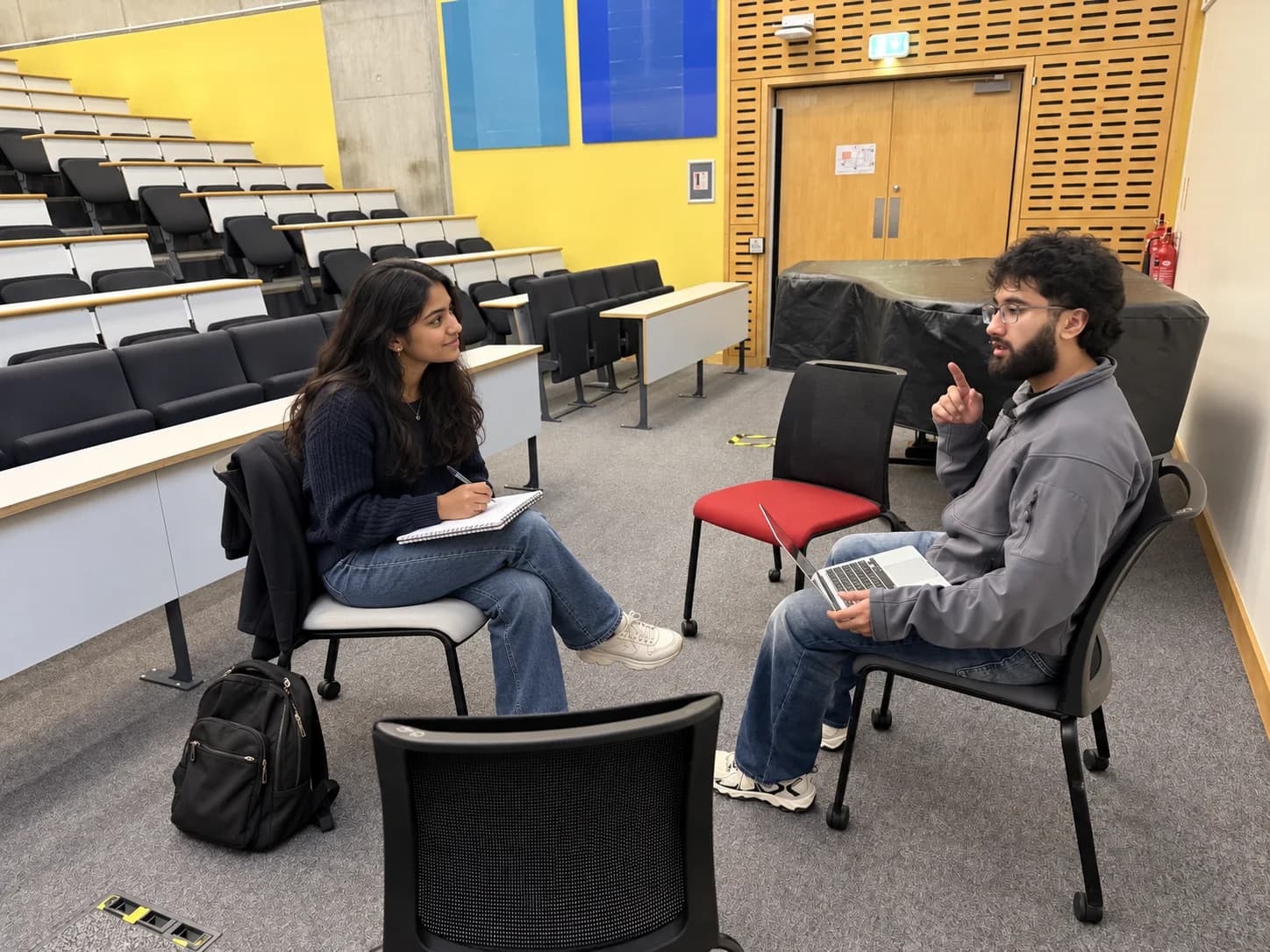A tutor and student practising interview answers together.